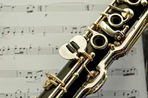 Clarinet lying on top of a music sheet.