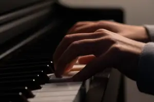 Focus on hands playing the piano. hands playing the pian.